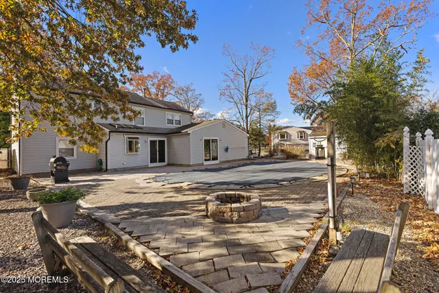 a view of a white house with a yard