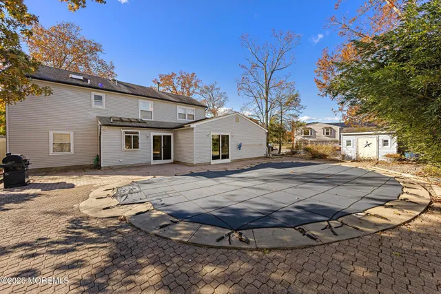 a view of a white house with a wooden fence