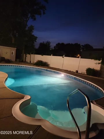 a view of a swimming pool with a yard