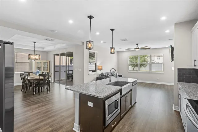a view of a livingroom with furniture and a ceiling fan