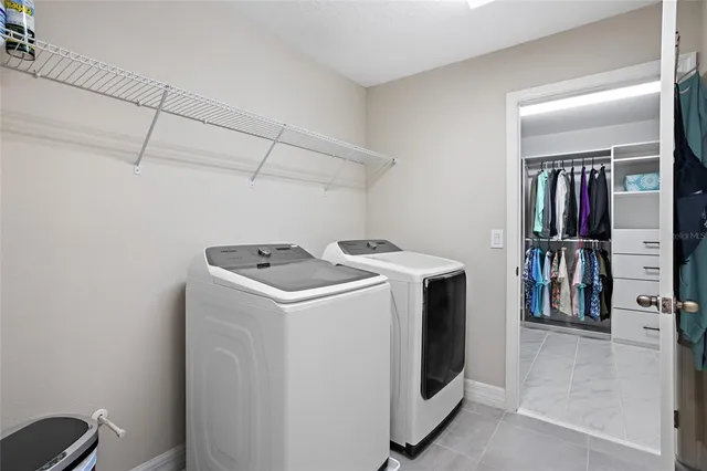 a bathroom with a granite countertop sink double mirror bathtub shower and a toilet