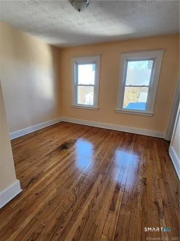an empty room with windows and cabinet