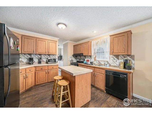 a kitchen with stainless steel appliances granite countertop a stove a sink dishwasher and a refrigerator