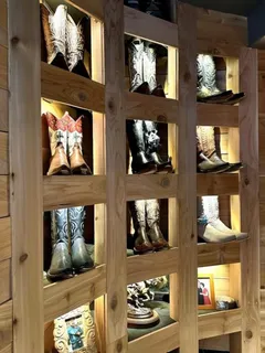 a kitchen with stainless steel appliances kitchen island a sink a stove and white cabinets