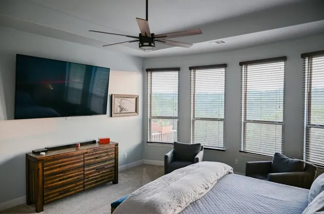 a bedroom with a bed and a chair