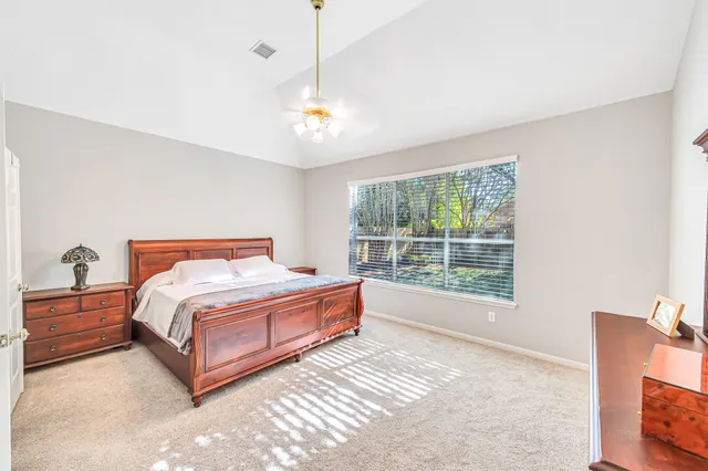 a spacious bedroom with a bed and a window