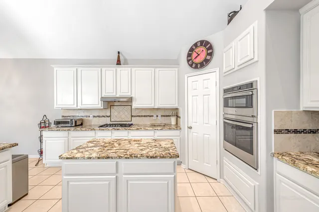 a kitchen with a stove and a refrigerator