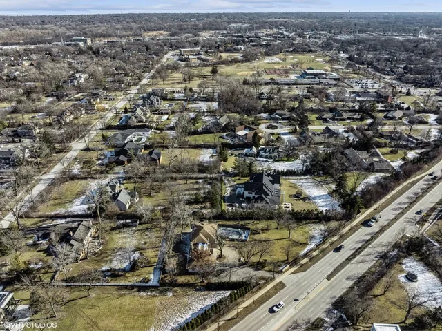 an aerial view of a house with a yard and lake view
