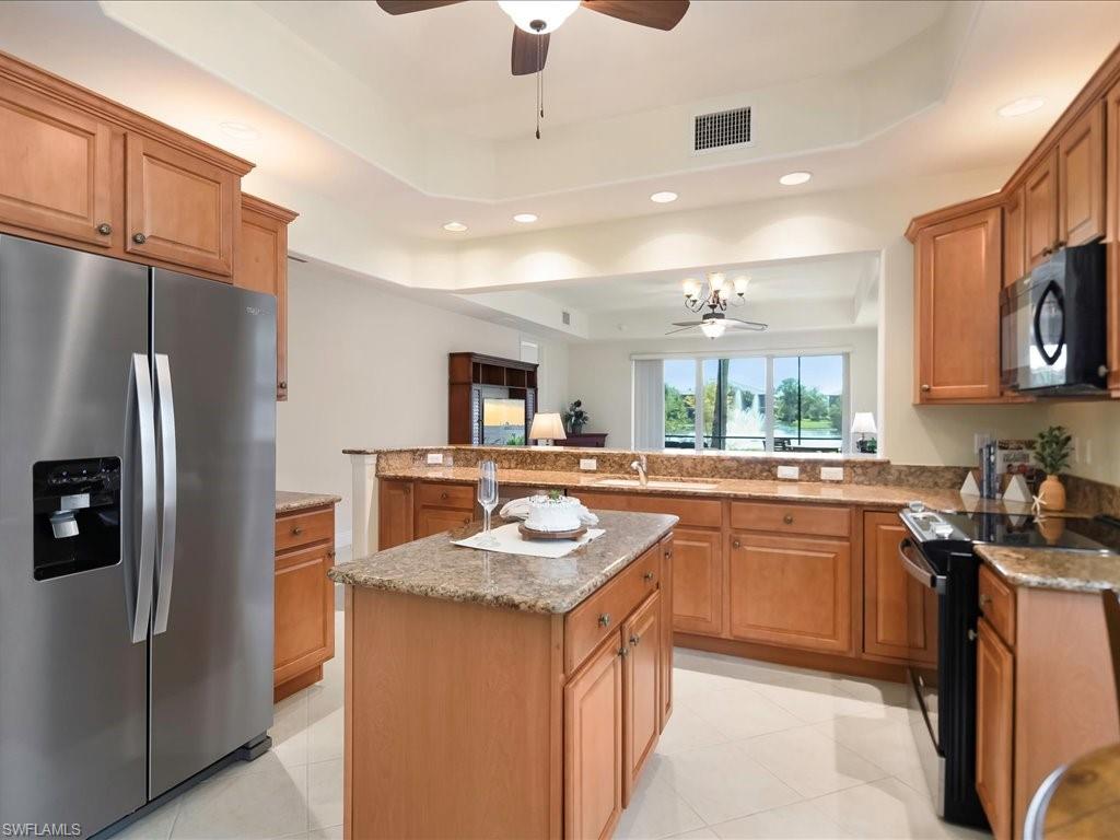 7832 Hawthorne Drive, Unit 1902 Naples, FL 34113 - Photo 11 of 43 a kitchen with stainless steel appliances granite countertop a sink stove and refrigerator