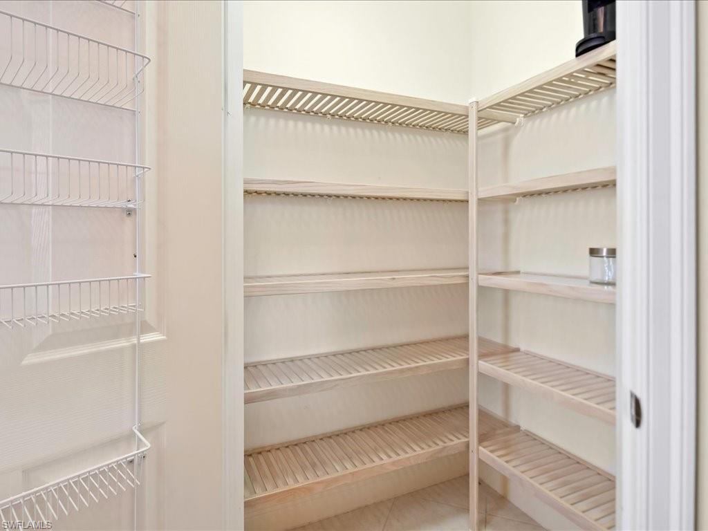 7832 Hawthorne Drive, Unit 1902 Naples, FL 34113 - Photo 13 of 43 a view of walk in closet with empty racks