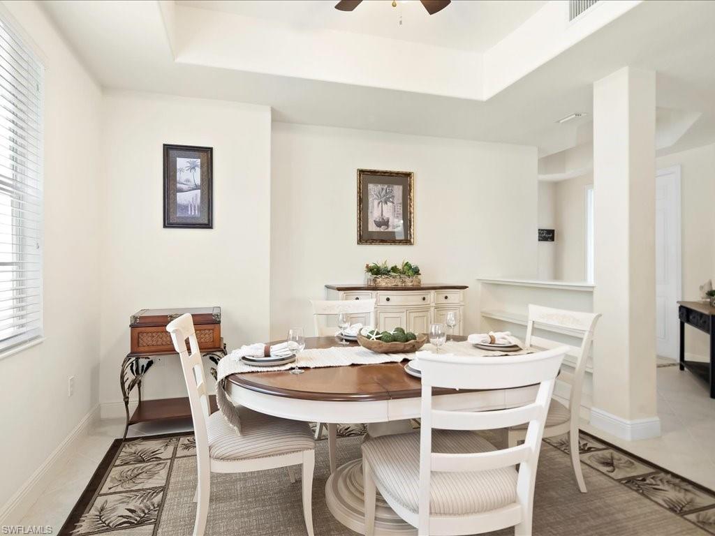 7832 Hawthorne Drive, Unit 1902 Naples, FL 34113 - Photo 15 of 43 a dining room with furniture and wooden floor
