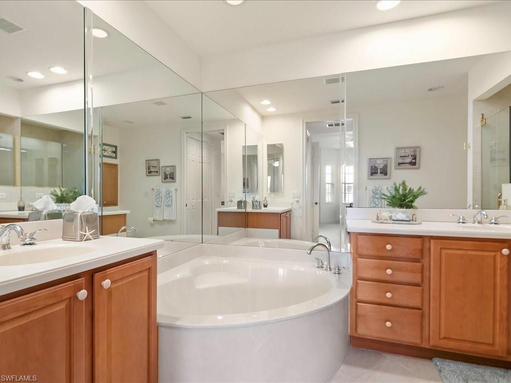 7832 Hawthorne Drive, Unit 1902 Naples, FL 34113 - Photo 18 of 43 a spacious bathroom with a double vanity sink mirror and double