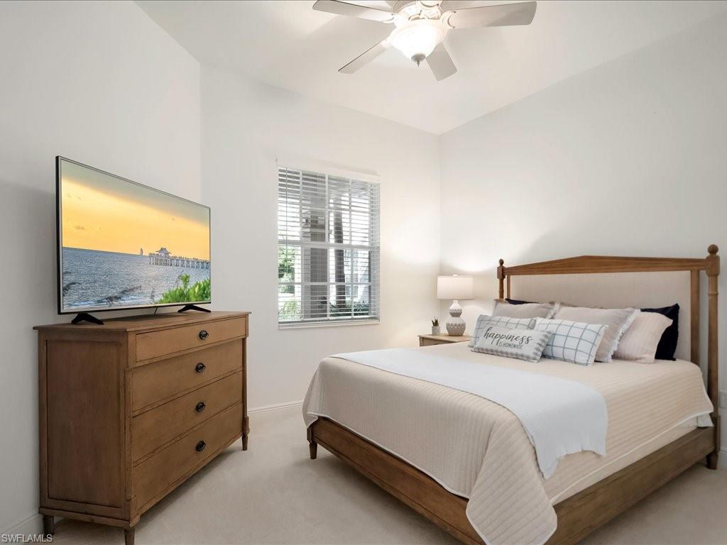 7832 Hawthorne Drive, Unit 1902 Naples, FL 34113 - Photo 21 of 43 a bedroom with a bed and a flat screen tv