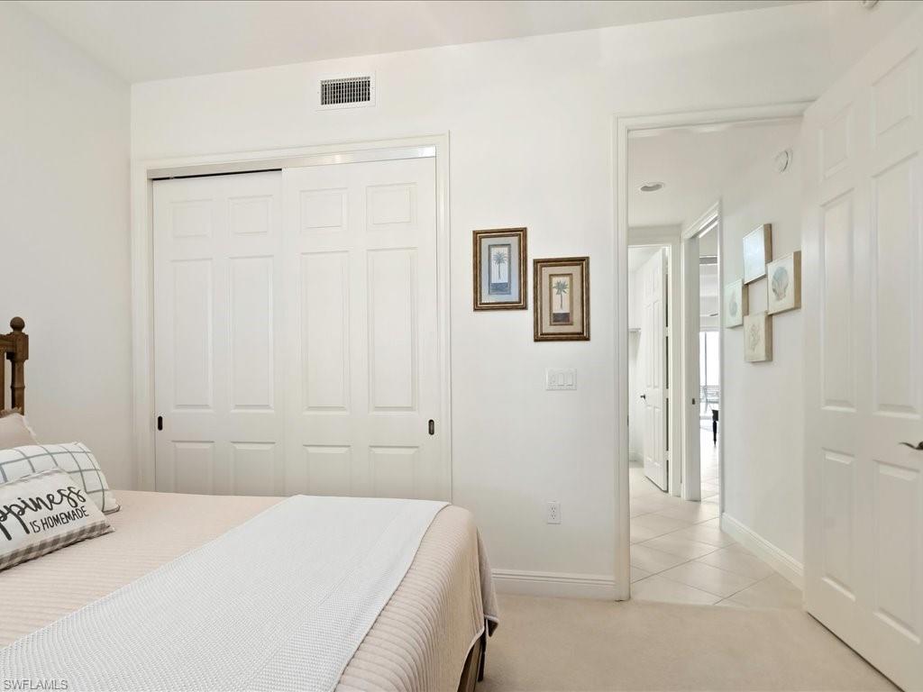 7832 Hawthorne Drive, Unit 1902 Naples, FL 34113 - Photo 22 of 43 a bedroom with a bed and a shower