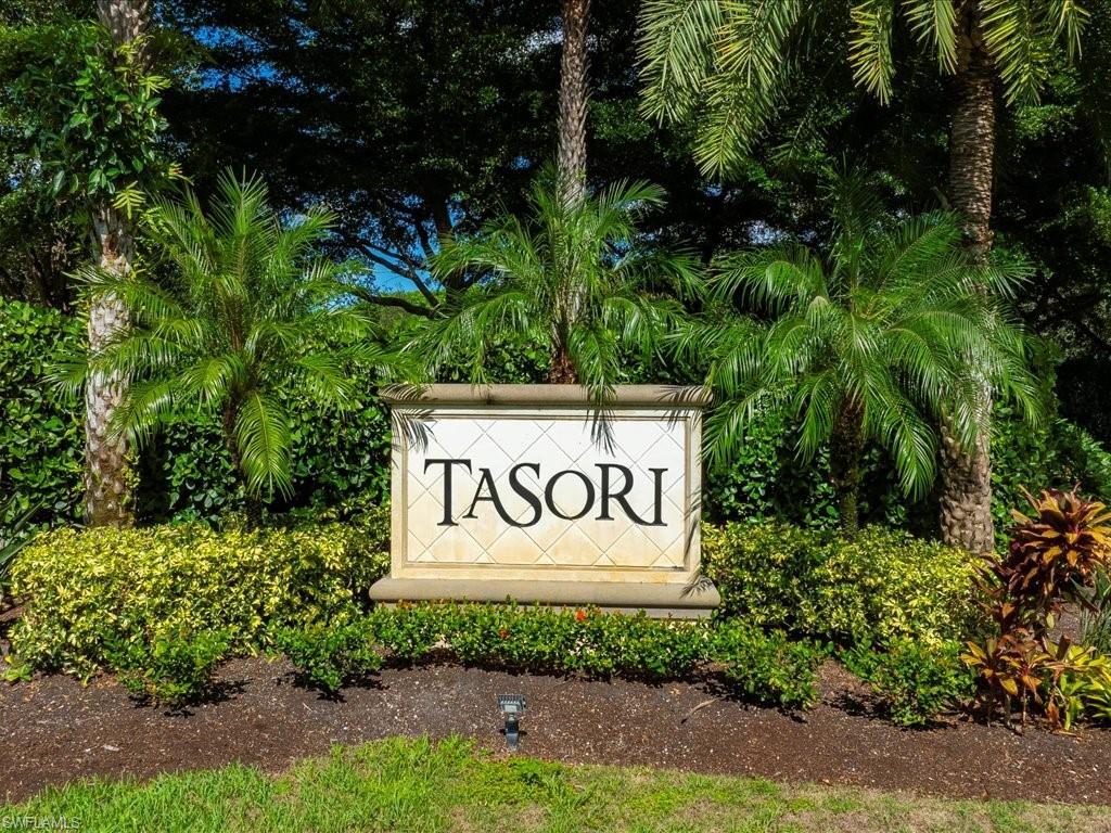 7832 Hawthorne Drive, Unit 1902 Naples, FL 34113 - Photo 32 of 43 a sign that is sitting in front of flowers