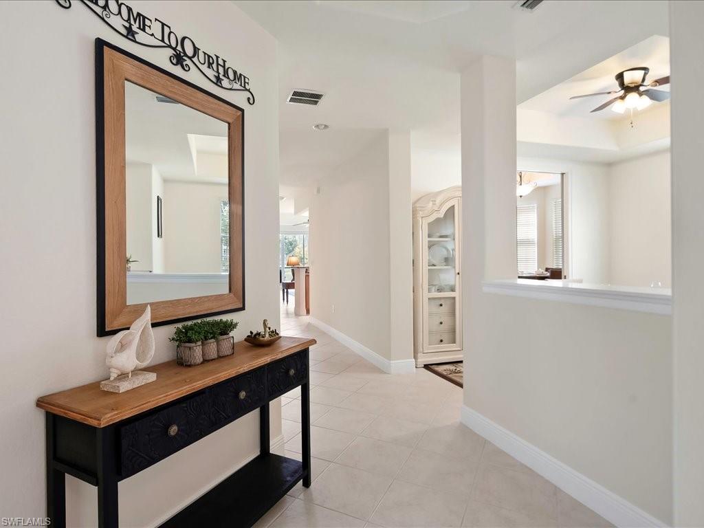 7832 Hawthorne Drive, Unit 1902 Naples, FL 34113 - Photo 4 of 43 a bathroom with a sink a mirror and a shower