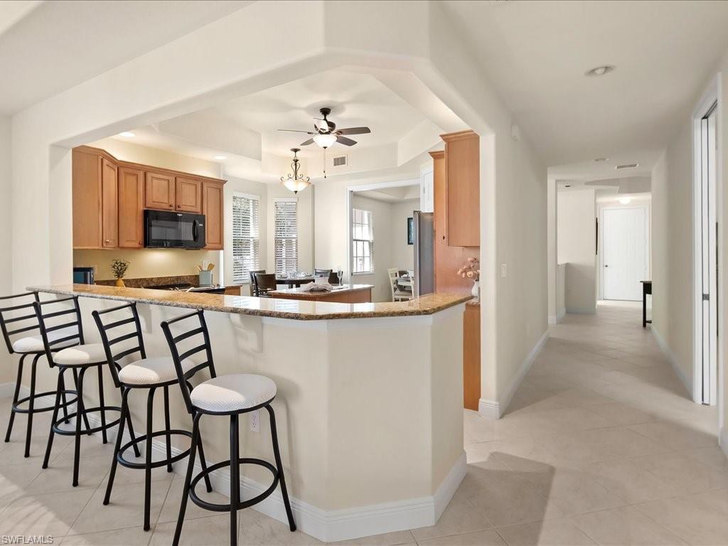 7832 Hawthorne Drive, Unit 1902 Naples, FL 34113 - Photo 8 of 43 a view of a livingroom with furniture and a flat screen tv