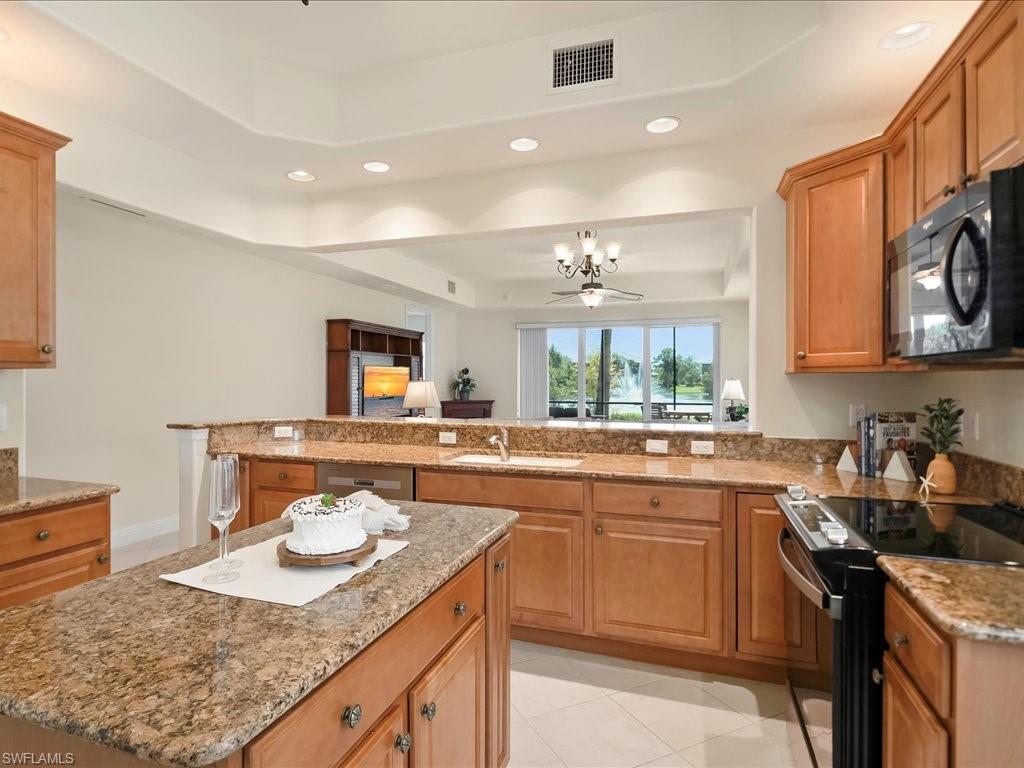 7832 Hawthorne Drive, Unit 1902 Naples, FL 34113 - Photo 10 of 43 a kitchen with a sink stove and cabinets