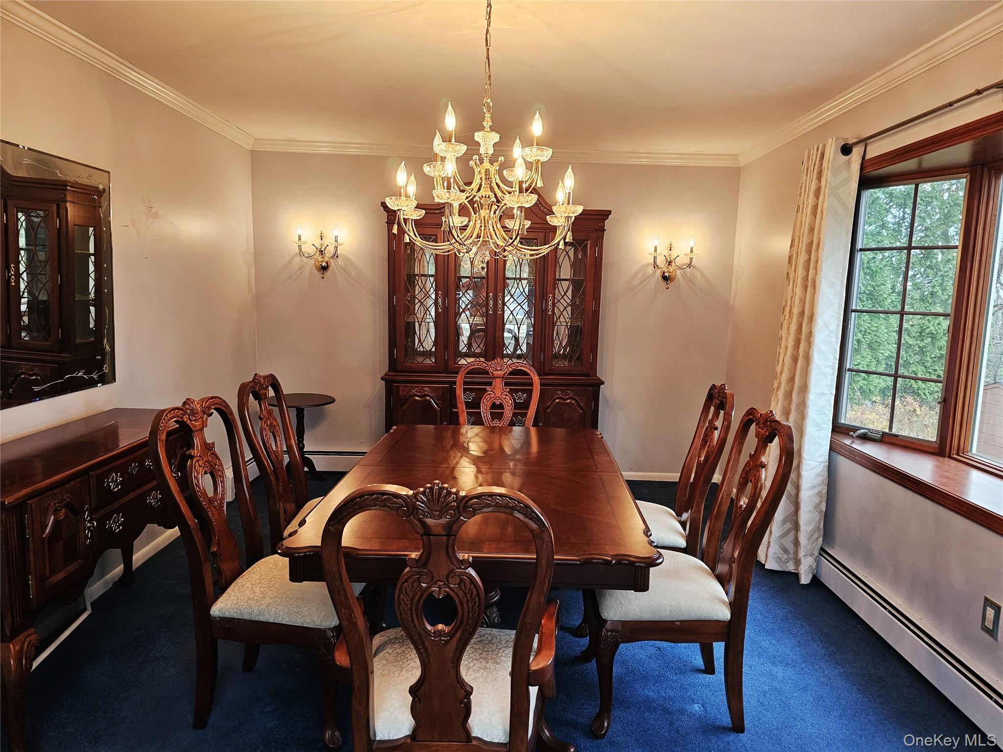 8 Laura Road Monroe, NY 10950 - Photo 2 of 12 Dining room with a baseboard radiator, ornamental molding, a chandelier, and carpet floors