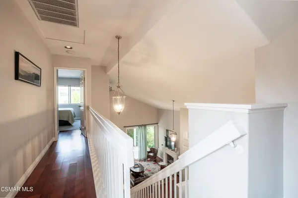 a view of a hallway with windows and stairs