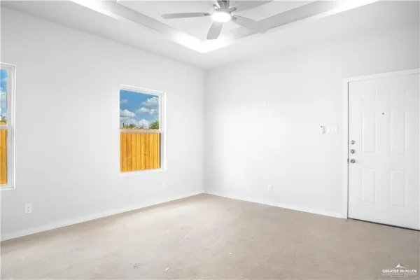 an empty room with a window and fireplace