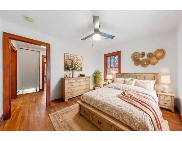 a view of a hallway with wooden floor and windows