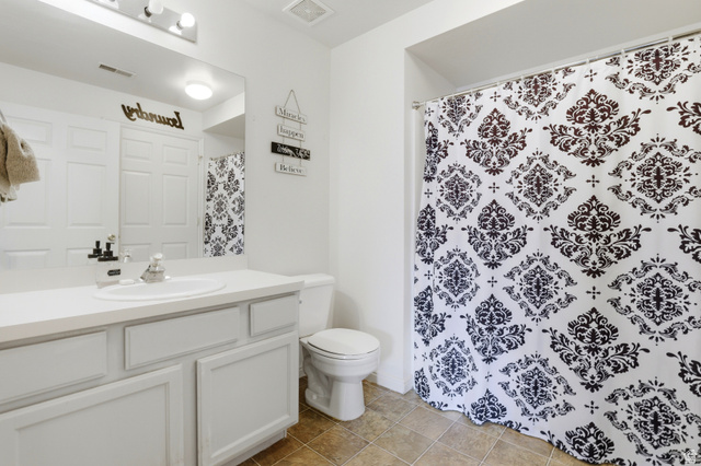 8083 North Ridge Loop East, Unit I 9 Eagle Mountain, UT 84005 - Photo 12 of 17 Full bathroom with vanity, a shower with curtain, and light tile patterned floors