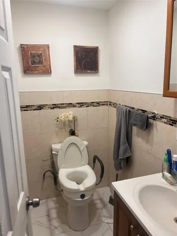 a white toilet sitting next to a bathroom sink