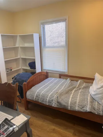 a bedroom with a bed and window
