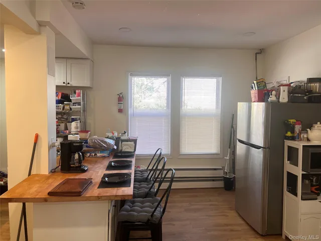 a dining room with furniture and a window