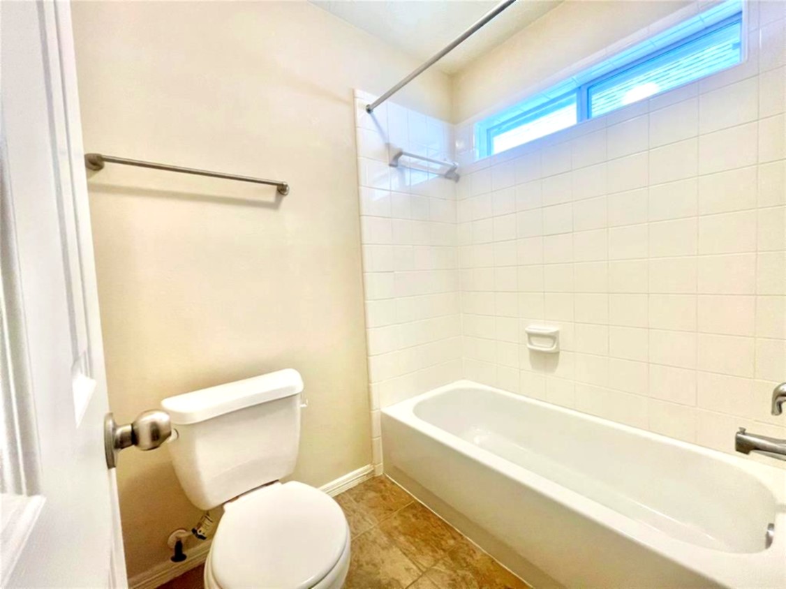 1622 Cohn Street Houston, TX 77007 - Photo 12 of 26 a white toilet sitting next to a bath tub