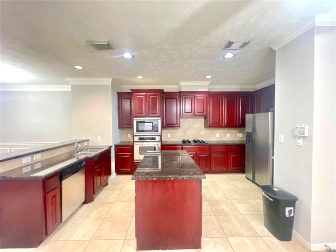 1622 Cohn Street Houston, TX 77007 - Photo 16 of 26 a large kitchen with stainless steel appliances granite countertop a stove refrigerator and a sink