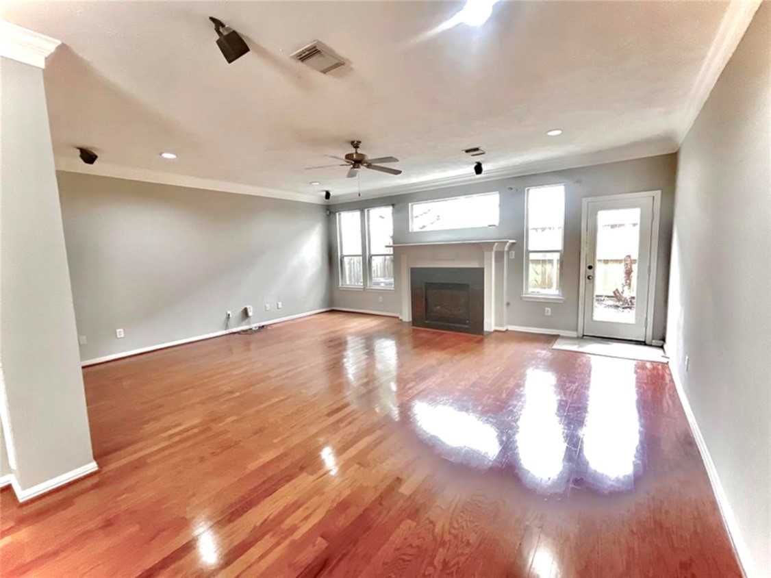 1622 Cohn Street Houston, TX 77007 - Photo 18 of 26 an empty room with windows and fireplace