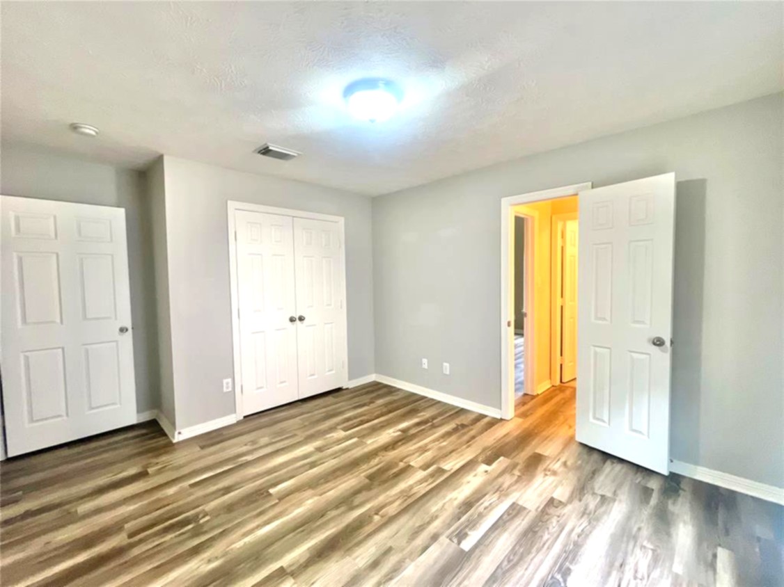 1622 Cohn Street Houston, TX 77007 - Photo 5 of 26 wooden floor in an empty room with a window
