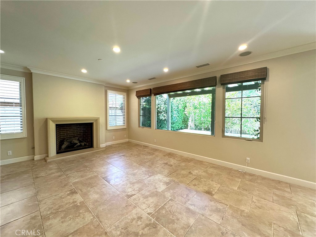53 Triana Irvine, CA 92618 - Photo 13 of 42 an empty room with a fireplace and windows
