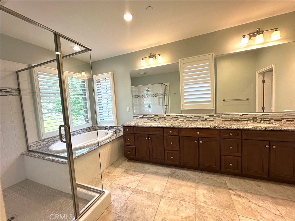 53 Triana Irvine, CA 92618 - Photo 18 of 42 a spacious bathroom with a granite countertop tub sink shower and mirror