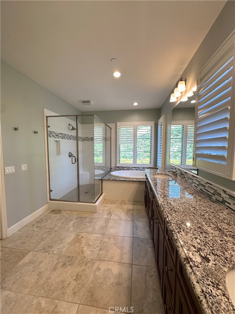 53 Triana Irvine, CA 92618 - Photo 19 of 42 a large white kitchen with granite countertop a sink and a stove