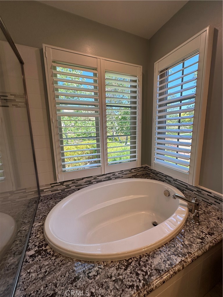 53 Triana Irvine, CA 92618 - Photo 22 of 42 a bath tub sitting in a bathroom next to a window