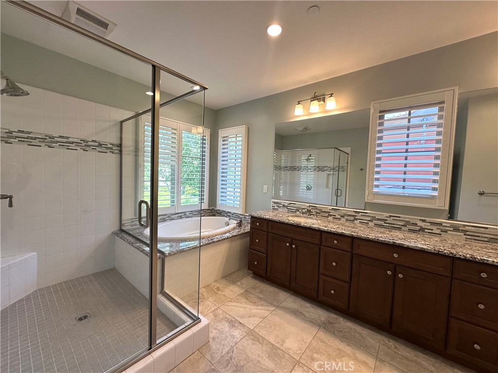 53 Triana Irvine, CA 92618 - Photo 24 of 42 a bathroom with a tub sink shower and mirror