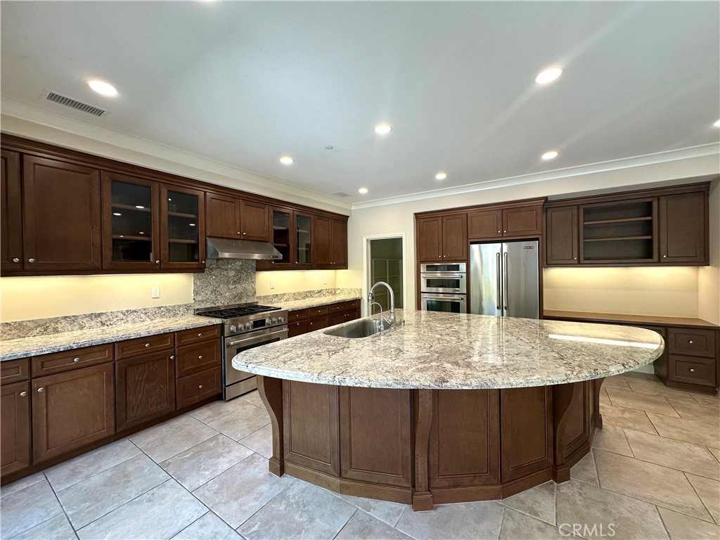 53 Triana Irvine, CA 92618 - Photo 7 of 42 a large kitchen with stainless steel appliances a large counter top