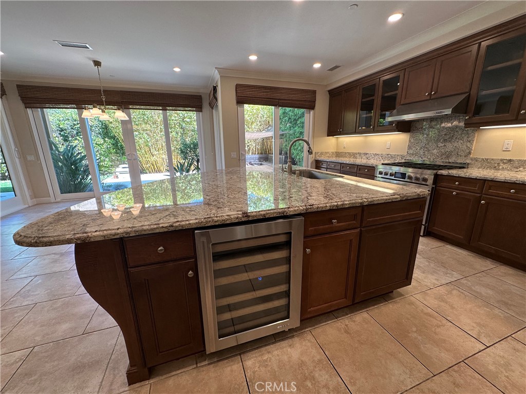 53 Triana Irvine, CA 92618 - Photo 8 of 42 a kitchen with granite countertop a stove sink and cabinets