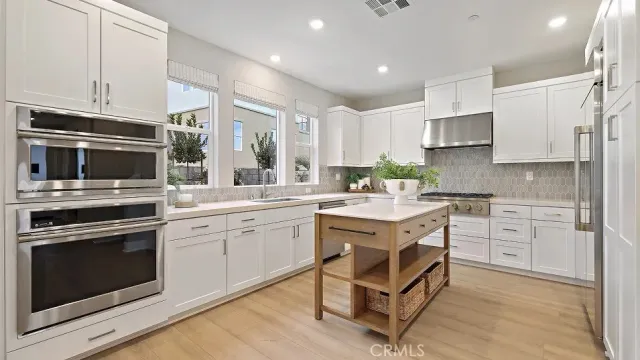 a kitchen with a sink stove and microwave
