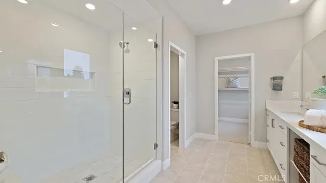 a spacious bathroom with a double vanity sink mirror and shower