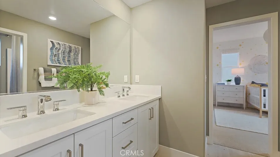 1711 Lychee Street Fullerton, CA 92835 - Photo 18 of 29 a en suite bathroom with a double vanity sink a mirror and a shower