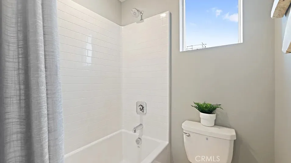 1711 Lychee Street Fullerton, CA 92835 - Photo 19 of 29 a bathroom with a toilet a sink a bath tub and mirror