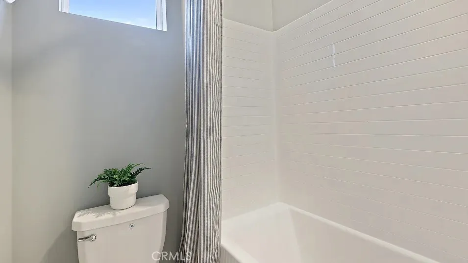 1711 Lychee Street Fullerton, CA 92835 - Photo 22 of 29 a bathroom with a shower curtain