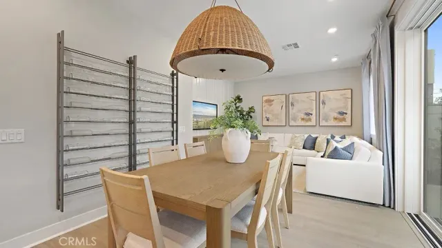 a living room with furniture a wooden floor and a chandelier