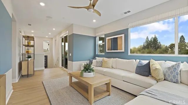 a living room with furniture and a large window