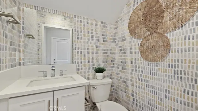 a bathroom with a sink a toilet and mirror