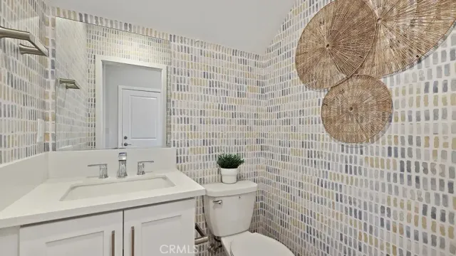 a bathroom with a sink a toilet and mirror